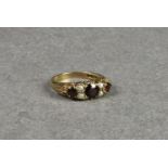 An antique style 9ct gold, garnet and seed pearl ring, size P½.