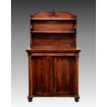 A William IV mahogany chiffonier, the shaped, waterfall top with two shelves on turned and S-