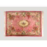 A Chinese Aubusson style wool rug, fourth quarter 20th century, the pink field with central ivory