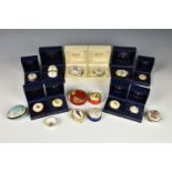 A collection of sixteen enamel and porcelain pill boxes, comprising a Royale Stratford Old Golfers
