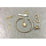A small collection of 9ct gold jewellery, to include a bangle; pair of hoop earrings; cameo