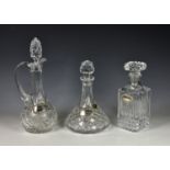 Two cut glass decanters and Claret jug with silver labels, comprising of a Bohemia cut glass ships