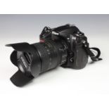 A Nikon D300 DSLR Digital Camera with AF-S Nikkor 18-200mm lens, and carry case, together with a