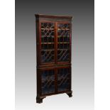 A Victorian mahogany floorstanding glazed corner cabinet, in the George III style, the fluted and