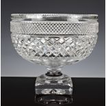A cut glass crystal pedestal punch bowl, probably Waterford, with cross hatch and hobnail cutting,