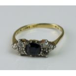 A 1930s seven stone 18ct gold sapphire and diamond ring, band misshapen, the bow-shaped setting with