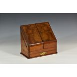 A Victorian burr walnut stationary box, the hinged two-part front opening to reveal a fitted