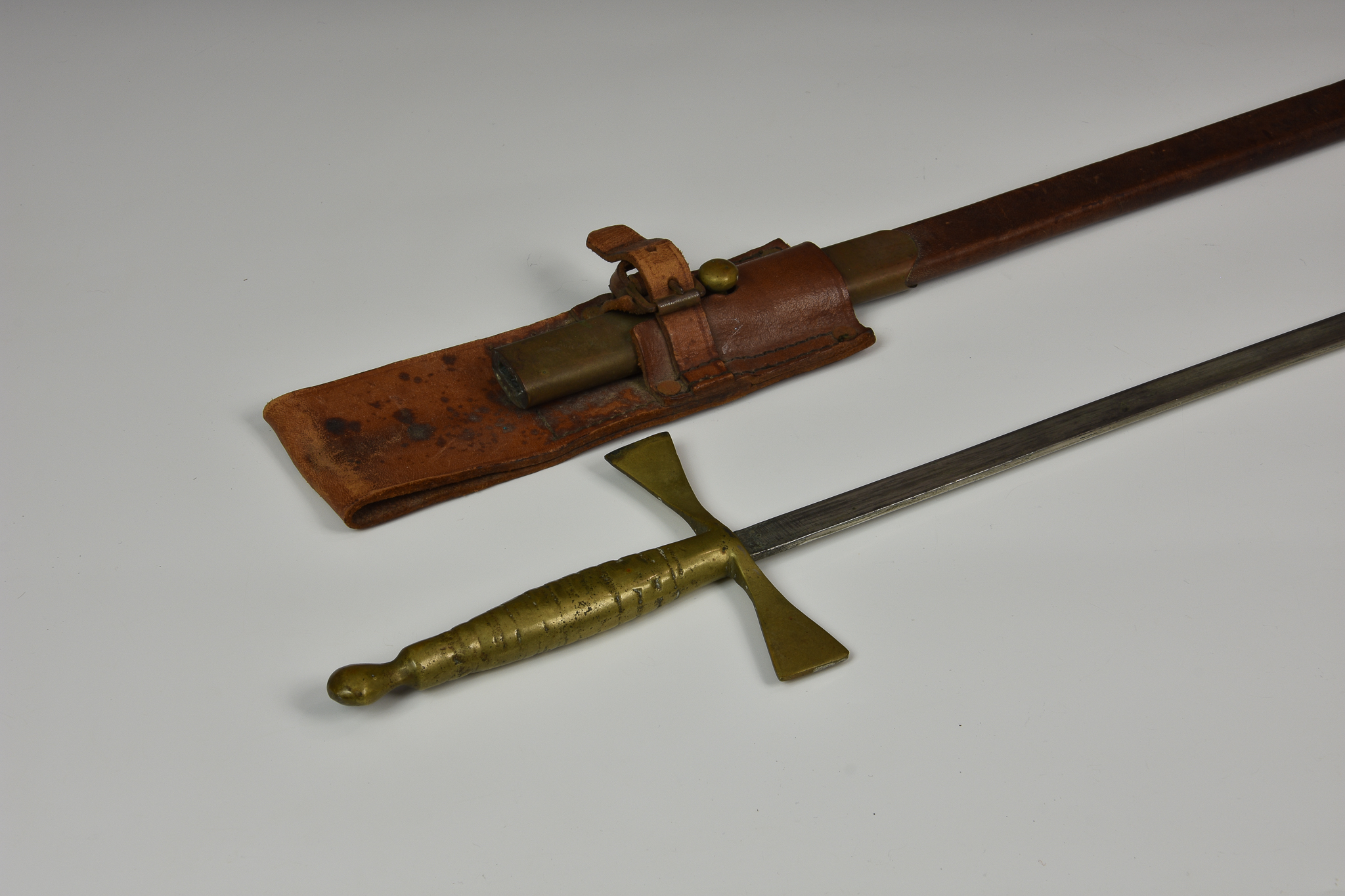 An unmarked Court Sword, brass handle, 27in. blade, brown leather scabbard.