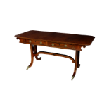 A fine George IV 'plum pudding' mahogany sofa table, the rectangular top with cut corner drop leaves