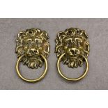 A pair of cast brass lion mask and ring door knockers, total drop with handle, 6in. (15.2cm.).