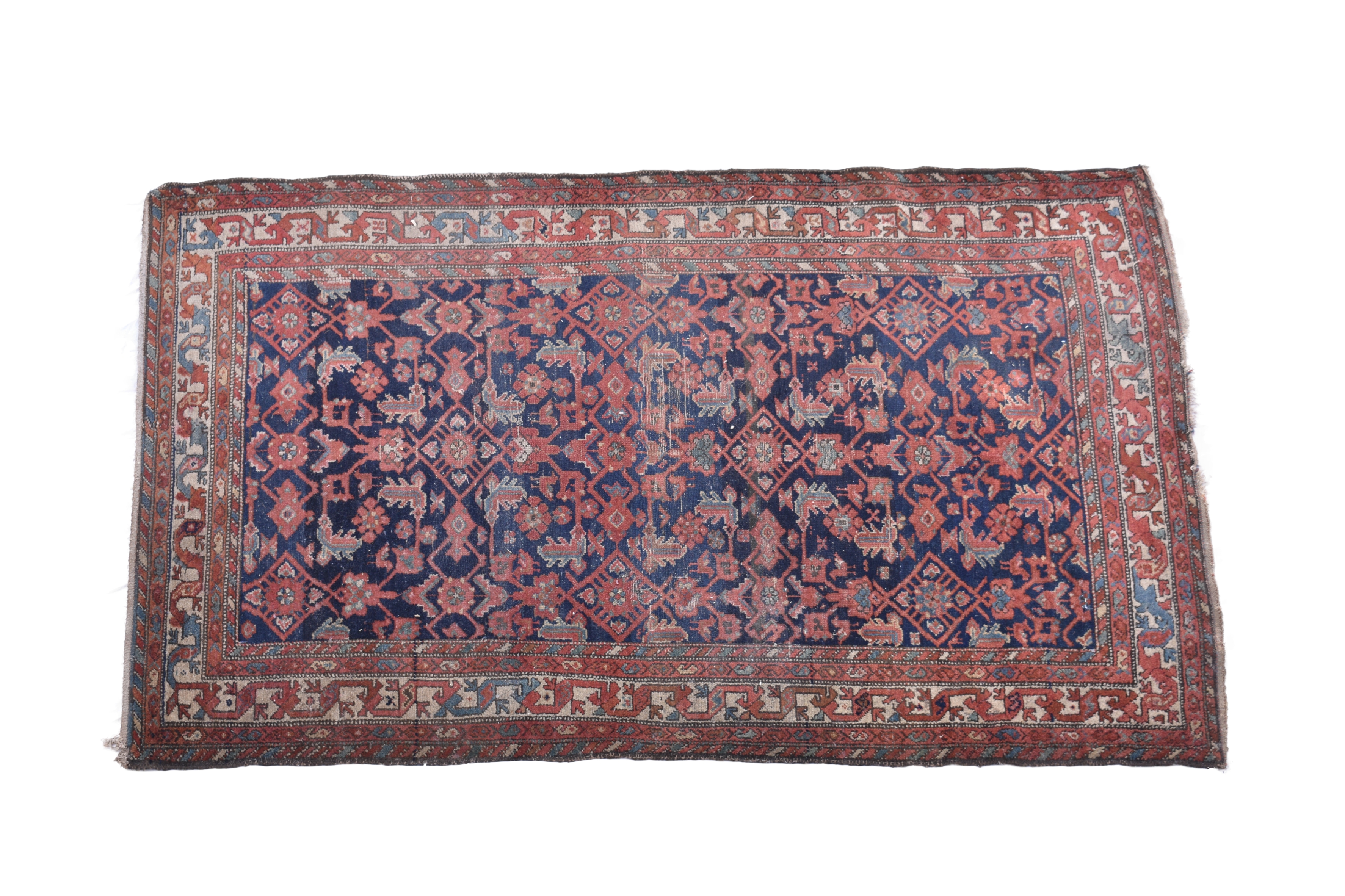 A Persian rug, early 20th century, the dark blue field with all over stylised floral and geometric