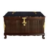 An antique style Oriental hardwood chest, late 20th century, the moulded serpentine lid over a