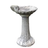 A composite stone scallop shell bird bath, with ribbed tapering column and scallop shell bath, 27in.