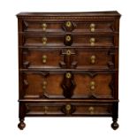 An early 18th century oak chest of drawers, the two plank top over a dentil frieze and four
