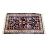A small Anatolian Dosemealti rug, the madder field with a single six sided medallion with stylised