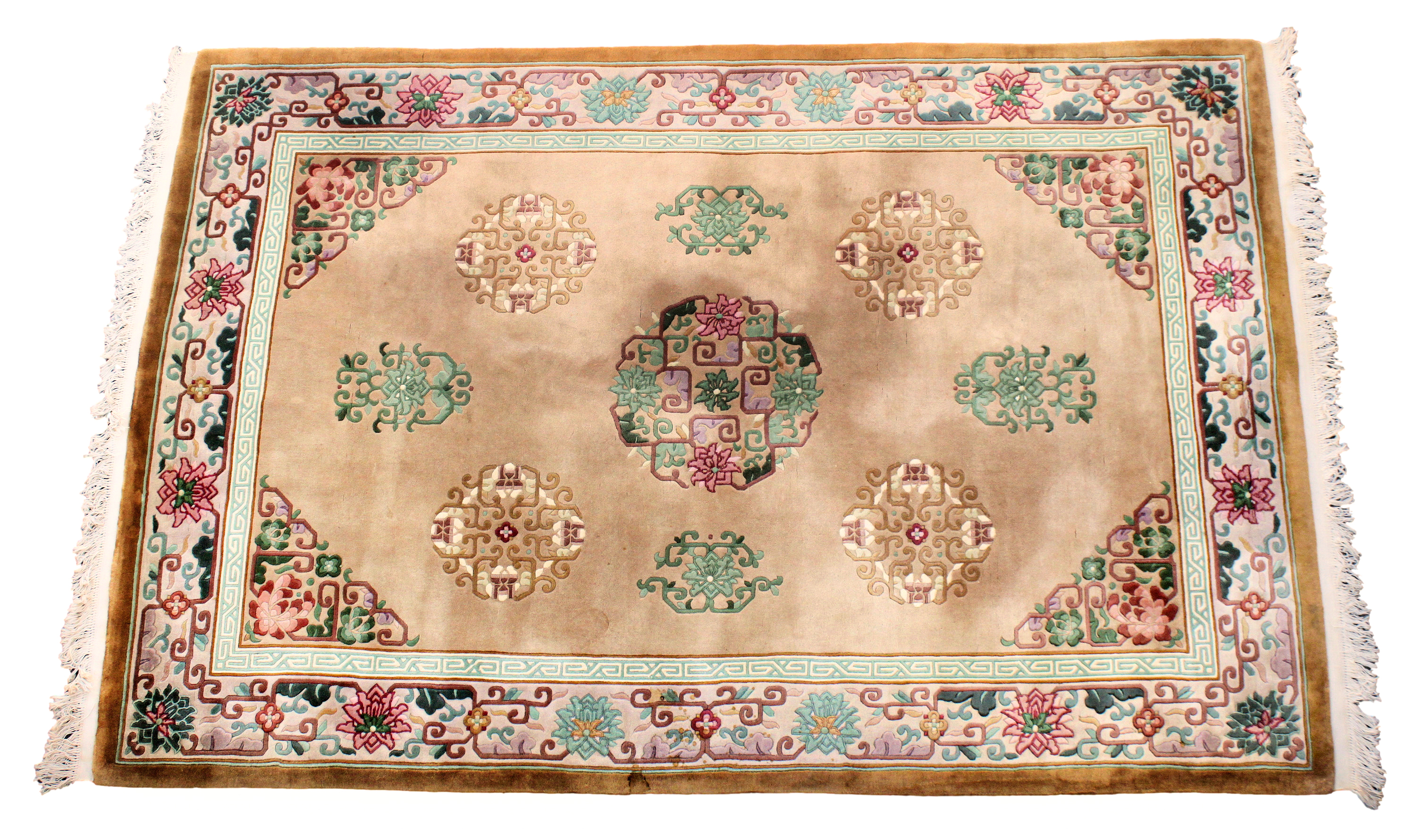 A Chinese Peking wool rug, late 20th century, with scrolled keywork and floral medallions and