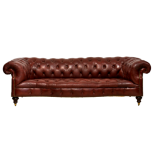 A Victorian leather serpentine Chesterfield sofa, in dark red buttoned leather, raised on turned