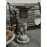 A composite stone figural Putto bird bath, figural column rising to attached circular dish, 30in. (