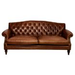 A button back brown leather three seater sofa, late 20th century, the serpentine back over studded