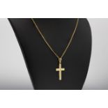 An 18ct gold cross on 9ct gold chain, the cross with reeded detailing and measuring 29x16mm.