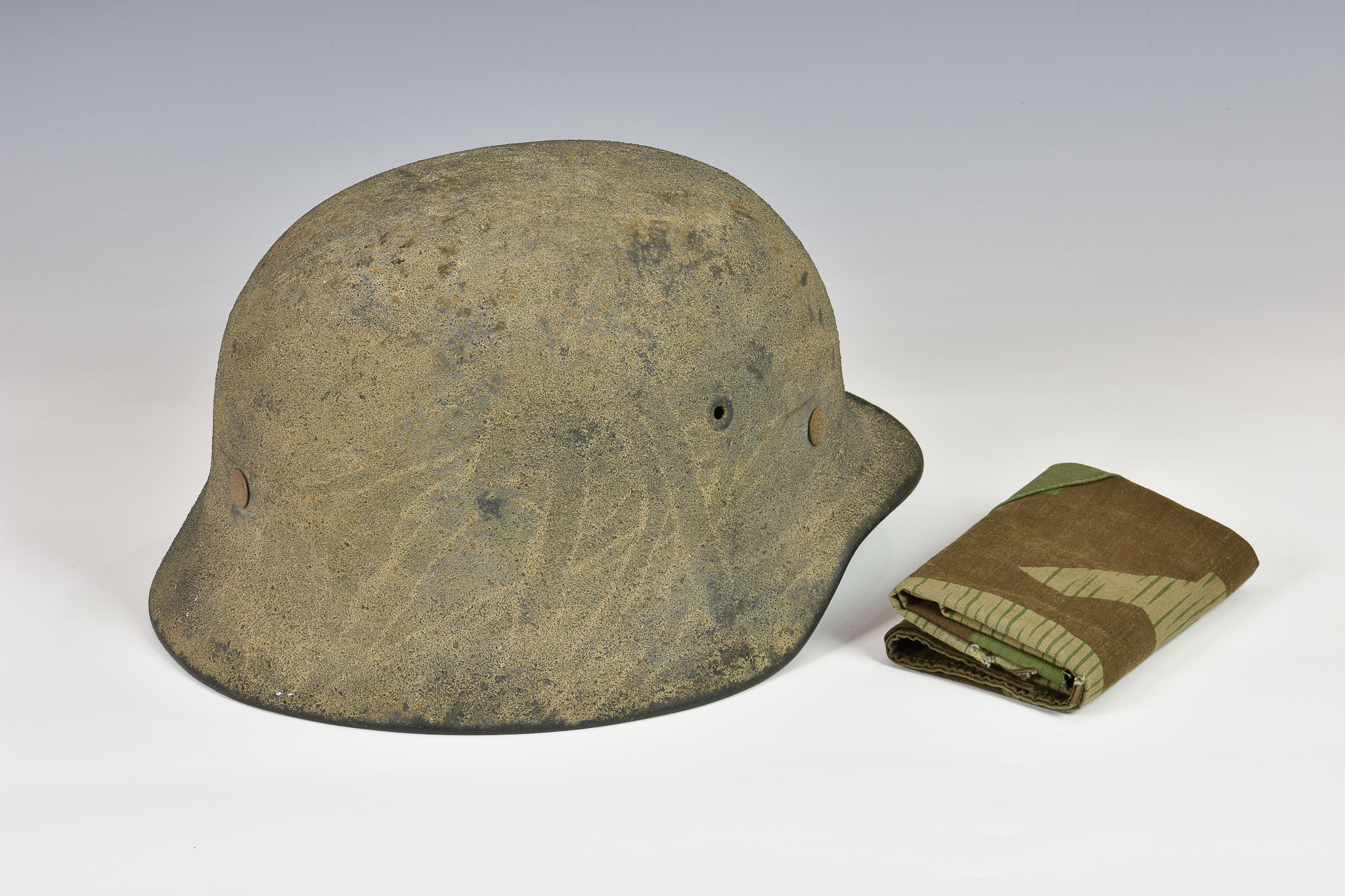 A WWII German M40 camouflaged steel helmet and liner with helmet cover, rolled rim and pressed vent, - Image 2 of 4