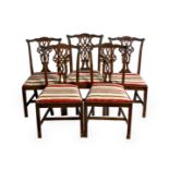 A set of five Victorian dining chairs in the George III Chippendale style, the yoke tope rail over a