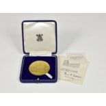 A Royal Mint 22ct gold medallion commemorating 900 years of Westminster Abbey, designed by Michael