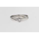 An 18ct white gold and diamond ring, the 0.21 carat brilliant cut diamond in a rub over setting,