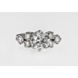 A platinum and diamond 7 stone ring, claw set with a graduated row of brilliant-cut diamonds,