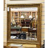 A 19th century style gilt mirror, the rectangular bevelled plate within a cavetto frame with