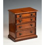 A late 19th or early 20th century miniature chest of drawers, having four long graduated drawers,