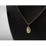 A 9ct gold ormer shell pendant, on an 18in. 9ct gold snake link chain.