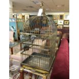 A 19th century style brass bird or parrot cage, with domed top with hanging loop, galvanised pull-