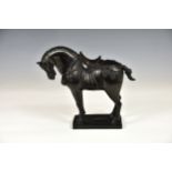 A Chinese patinated bronze Tang style horse, 20th century, dark brown patination, standing upon a