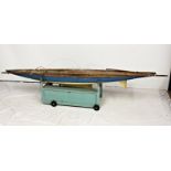A large 1960s pond yacht, 'Heron', with painted wooden hull, teak-style planked deck with central