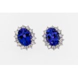 A pair of 18ct white gold, tanzanite and diamond cluster earrings, the oval cut tanzanites