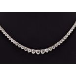 An 18ct white gold and diamond rivière necklace, featuring a graduated row of brilliant cut diamonds