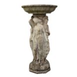 A composite stone figural bird bath, the central column depicting three classical maidens and