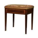 An Edwardian mahogany and satinwood piano stool, the needlework seat over a satinwood banded frieze,