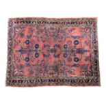 A small Persian rug, probably Mehriban, early 20th century, the muted pale aubergine field with