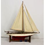 A 1950s wooden pond yacht, painted in red and cream, refurbished mid 1980's, weighted keel, complete