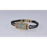 A 1930s 9ct gold cased ladies manual wrist watch, the 15 jewel movement signed 'EW', fronted by a