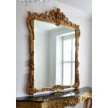 A large 18th century style giltwood mirror, late 20th century, the rounded rectangular plate