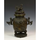 A large Chinese patinated bronze covered tripod censer, 20th century, the stout ovoid body cast in