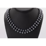 A black pearl opera length necklace with marcasite studded clasp, the pearls steel grey in colour