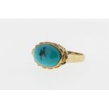 A 9ct gold and turquoise ring, featuring a horizontal cabochon turquoise held in a stylised