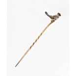 An antique diamond and ruby stickpin, featuring a miniature bird studded with rose cut diamonds,