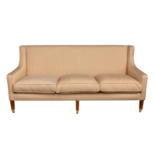 A matching pair of three seater sofas by KA International of Spain, raised on stained beechwood legs