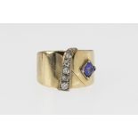 A modernist 9ct gold, tanzanite and diamond ring, the shank fashioned into a wide, flat band and