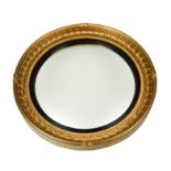 A carved giltwood Bullseye Mirror, the cavetto frame mounted with spherules, the convex mirror plate